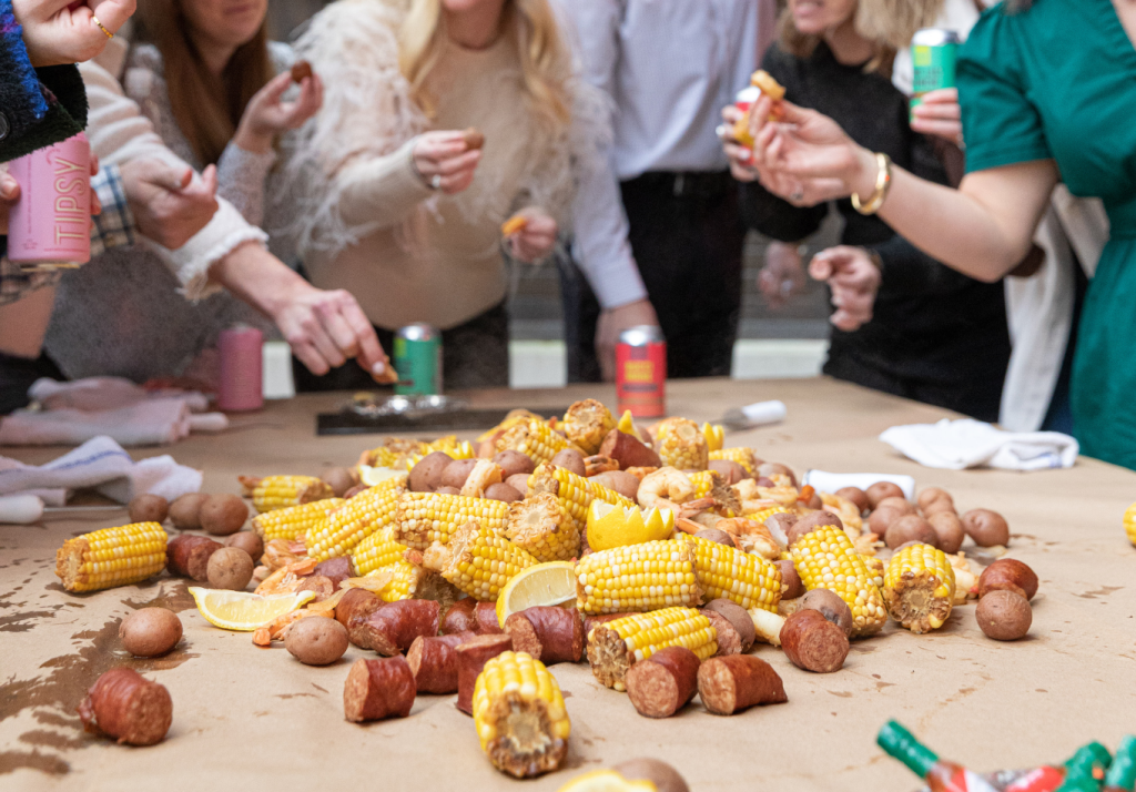 Guests enjoying a traditional Lowcountry boil during a wedding weekend event.