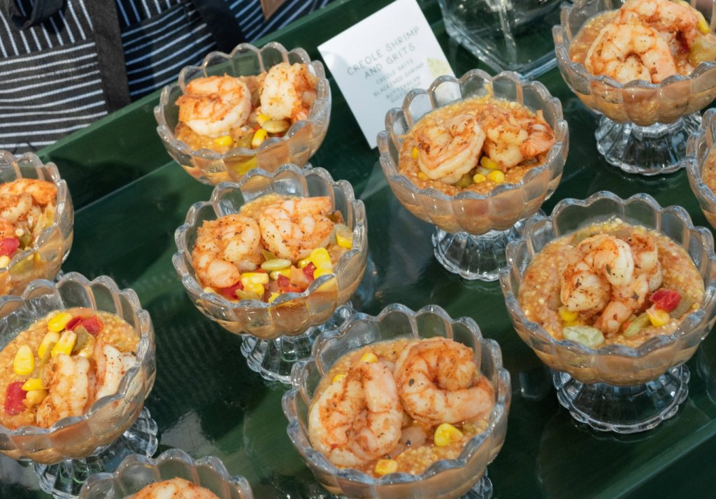Creole shrimp and grits served in glass bowls by Hamby Catering in Charleston