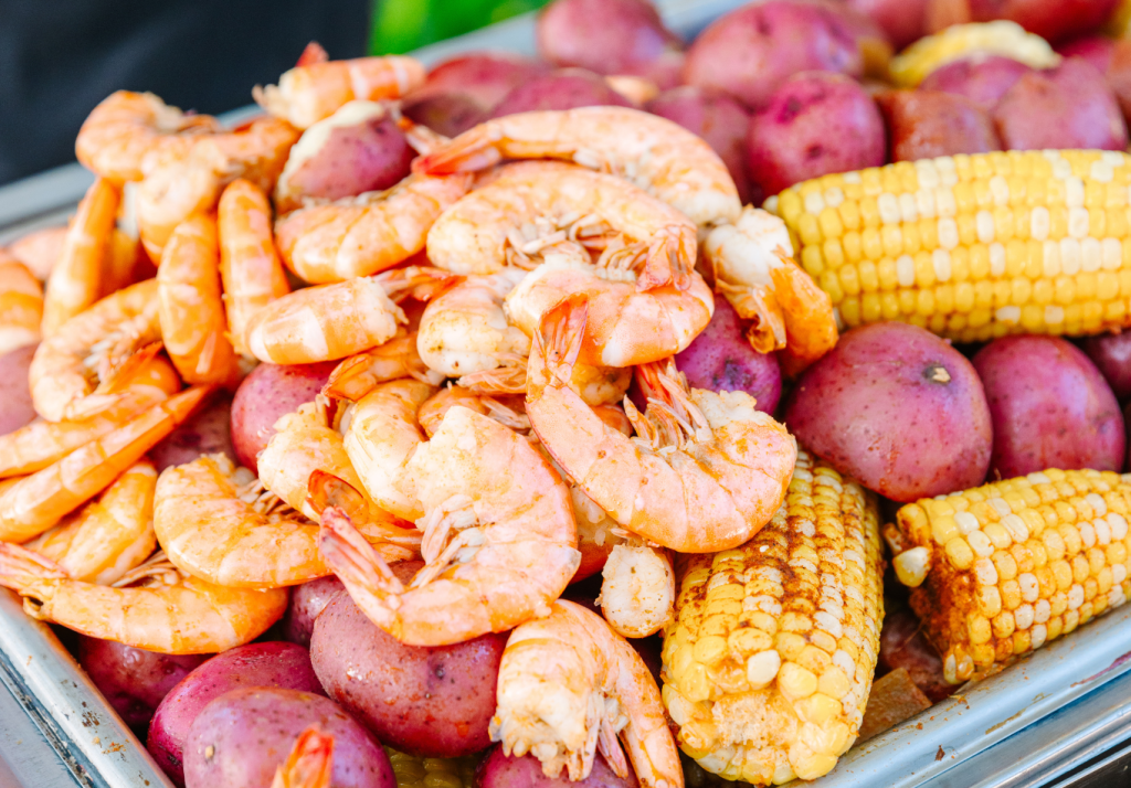 Lowcountry boil featuring shrimp, corn and red potatoes served at a Charleston wedding welcome party.