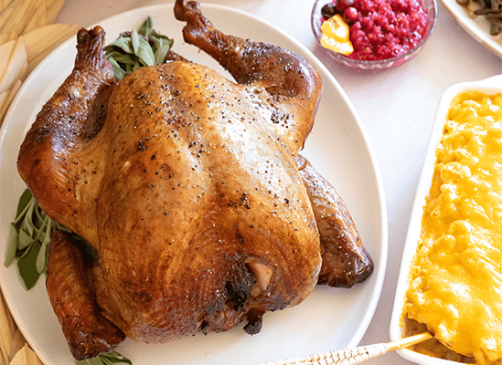 Presenting roasted turkey with classic Thanksgiving feast sides