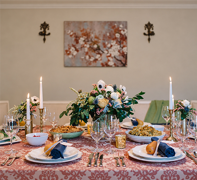 Setting a Thanksgiving dining table with catered holiday dishes